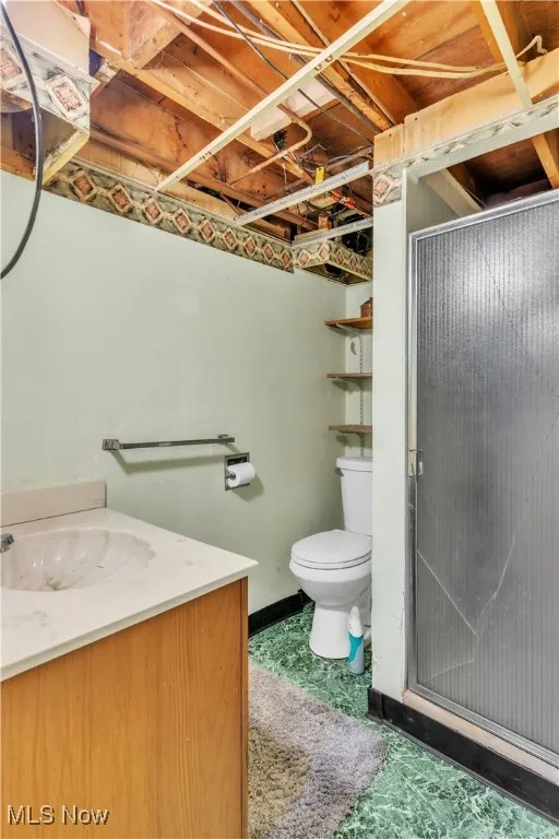 Full bath with vanity and a shower stall