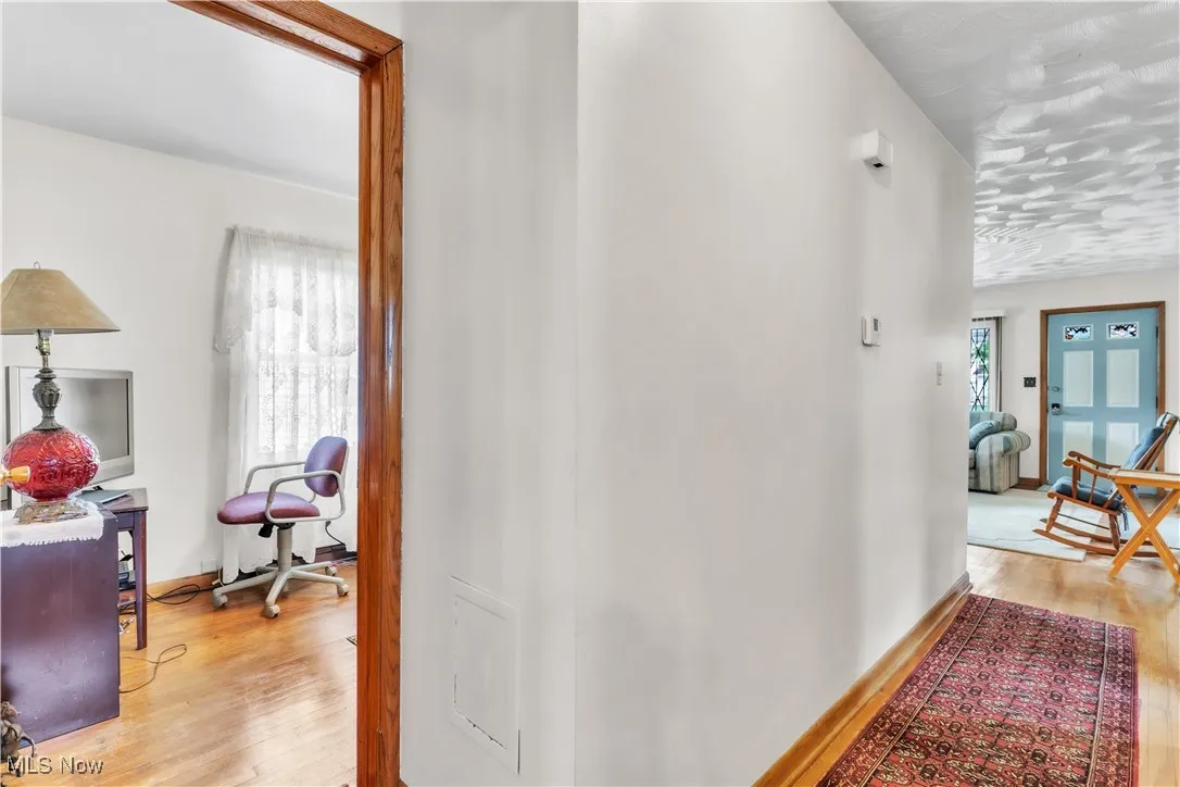 Hallway featuring light wood-style floors and baseboards
