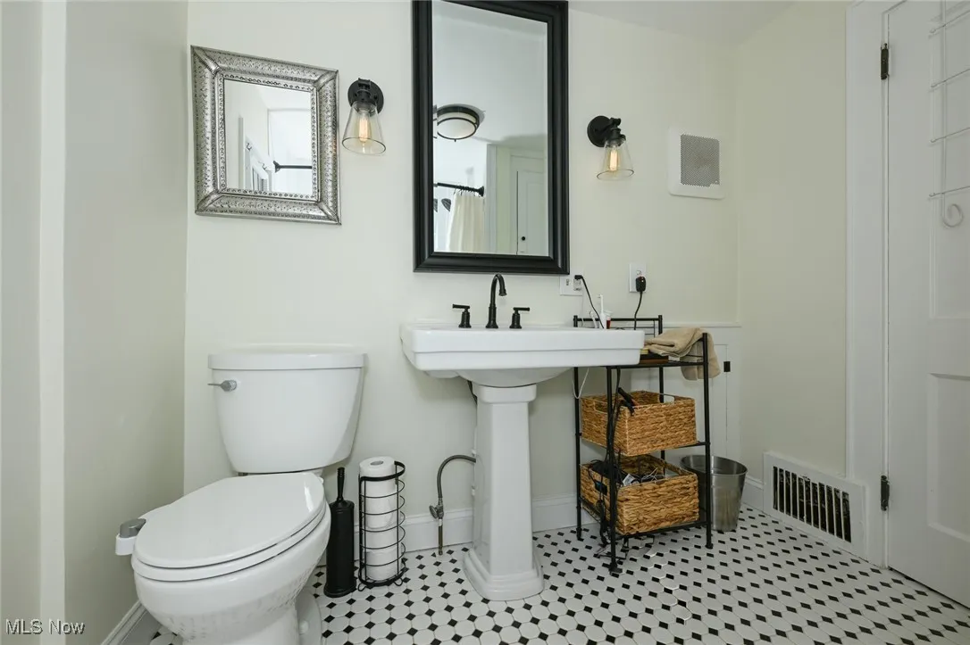 Full bath with toilet and baseboards