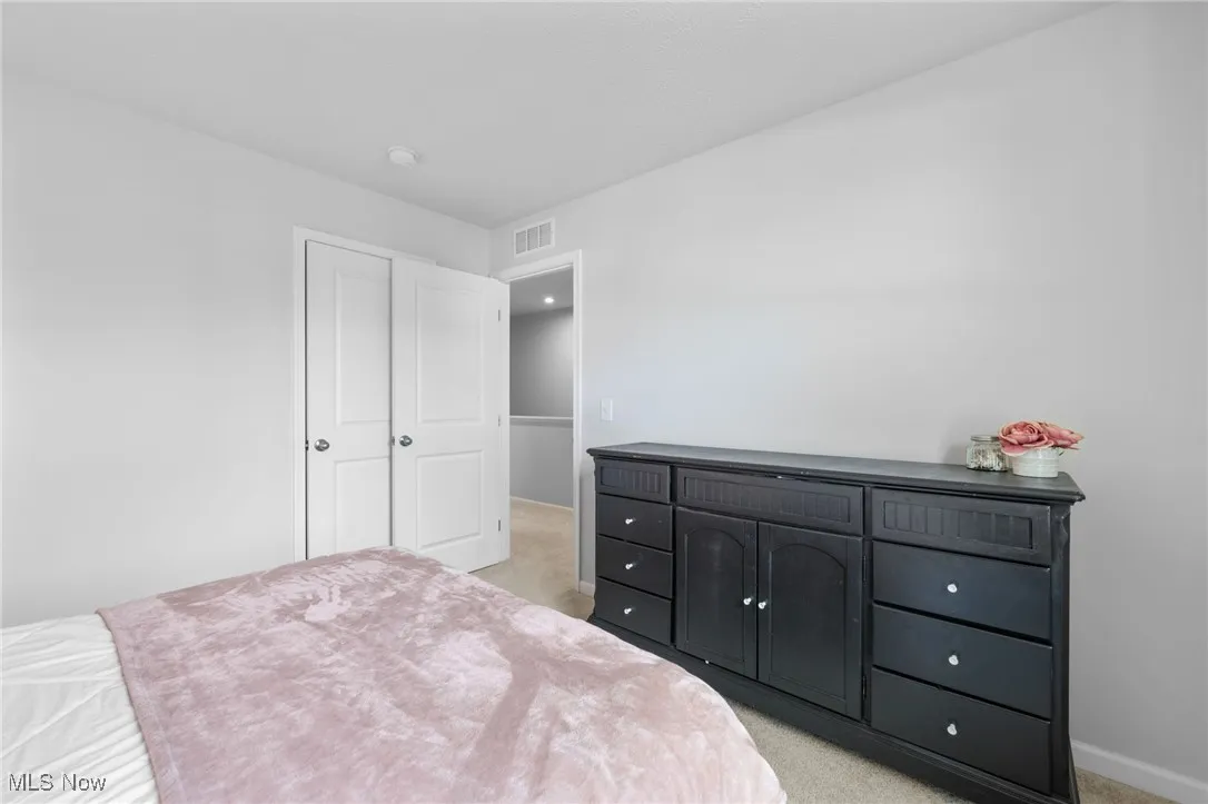 Bedroom with light carpet