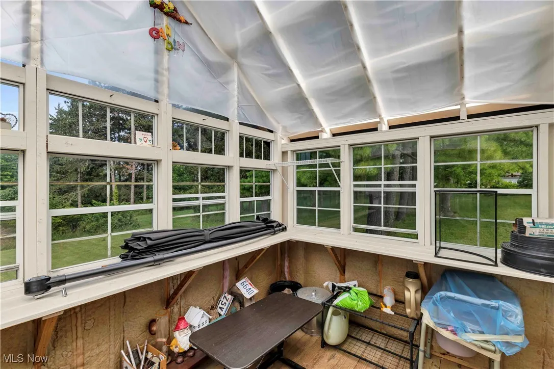 Sunroom / solarium with healthy amount of natural light and lofted ceiling