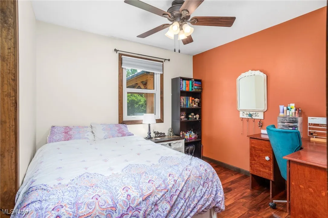 Bedroom with wood finished floors and a ceiling fan