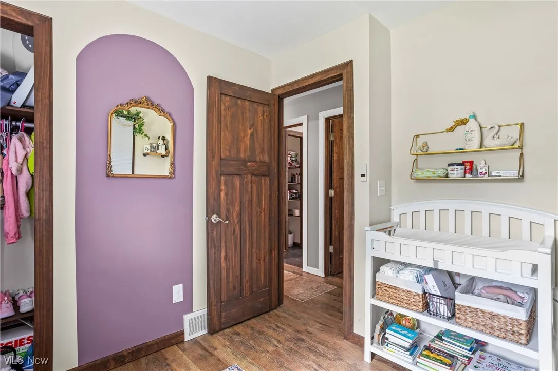 Bedroom featuring wood finished floors and baseboards