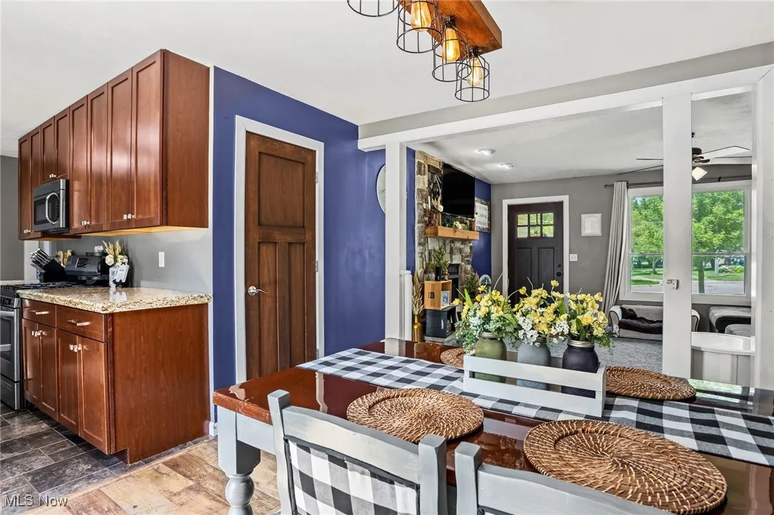 Kitchen featuring appliances with stainless steel finishes and ceiling fan