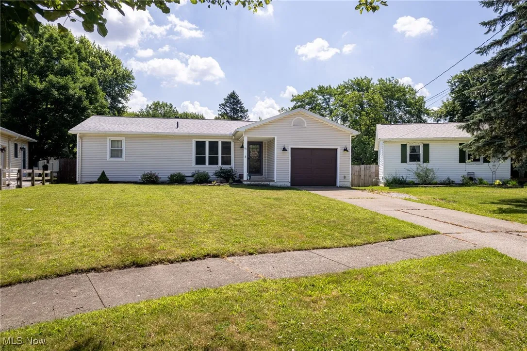 Ranch-style house featuring driveway and a garage