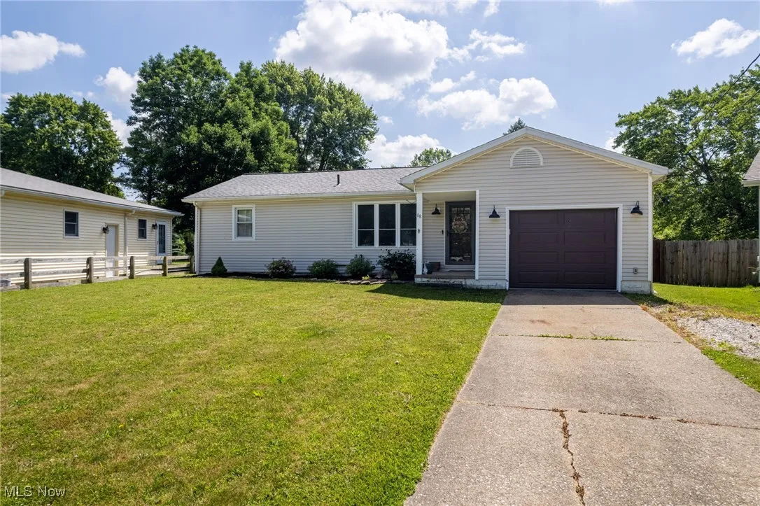 View of front facade featuring a garage and concrete driveway