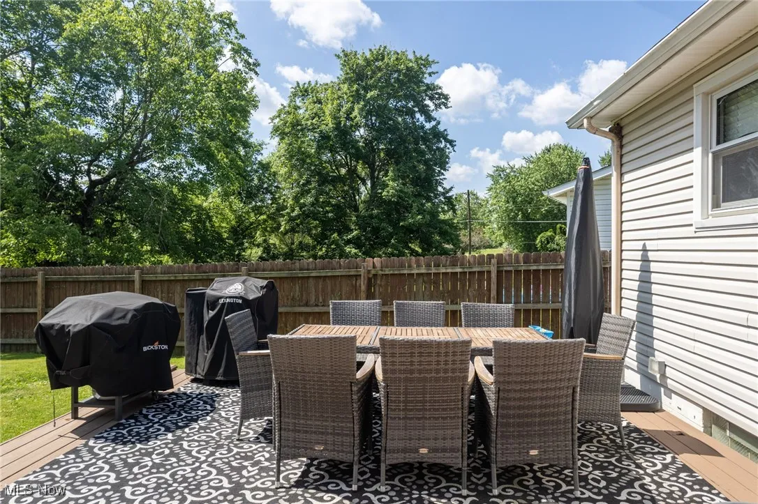 View of patio with area for grilling and outdoor dining area