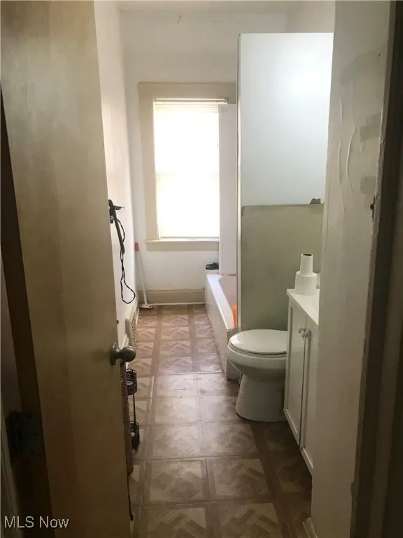 Full bath featuring vanity and tile patterned floors