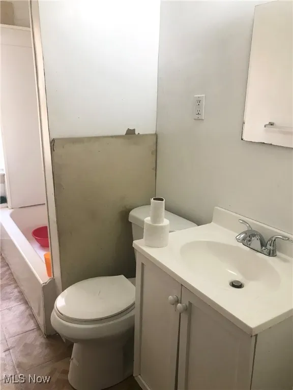 Bathroom with vanity and a tub to relax in