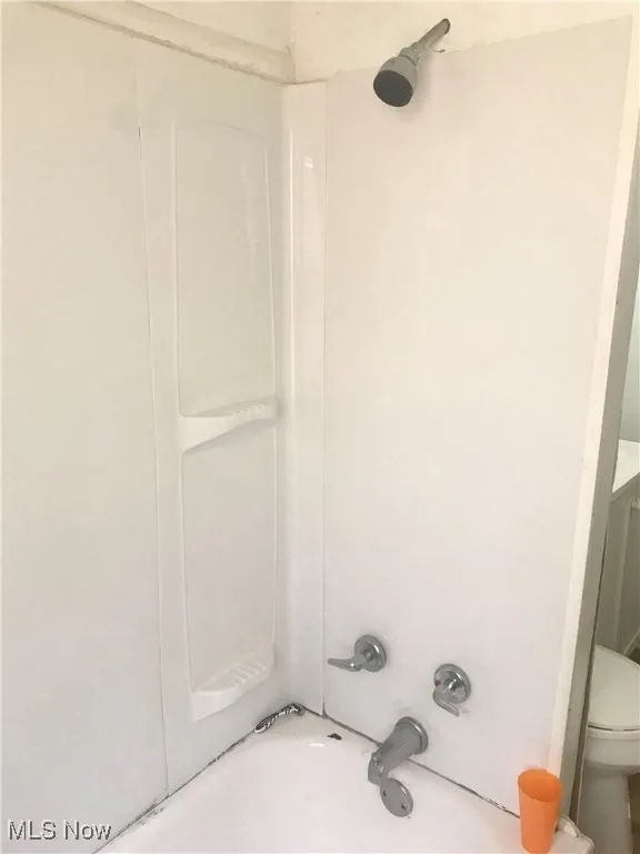 Bathroom with toilet and bathtub / shower combination