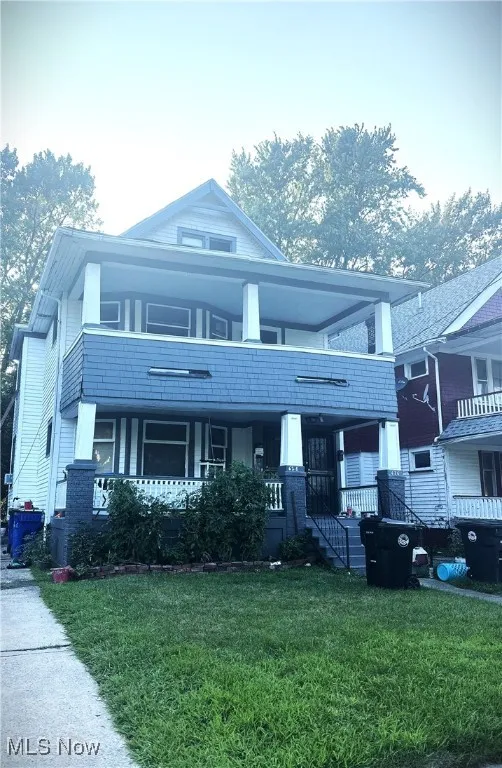 View of front of house with a front lawn and a porch