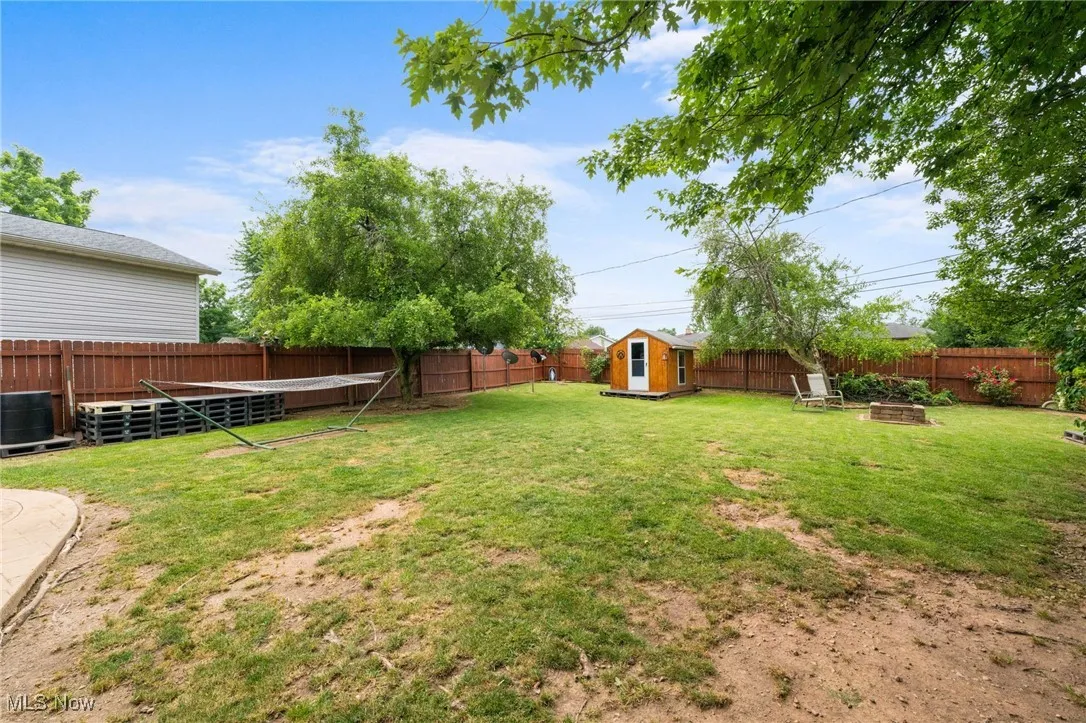 Fenced backyard with a storage shed