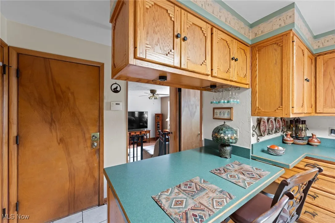 Kitchen with a ceiling fan and light tile patterned flooring