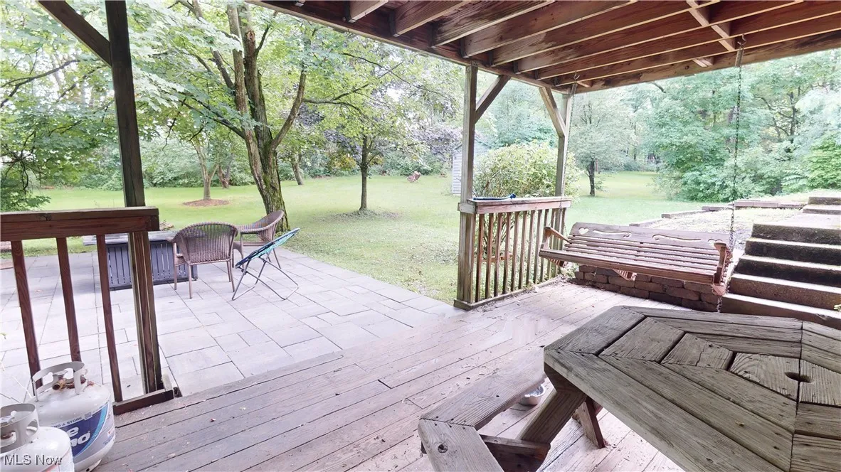 Deck with a yard and a patio