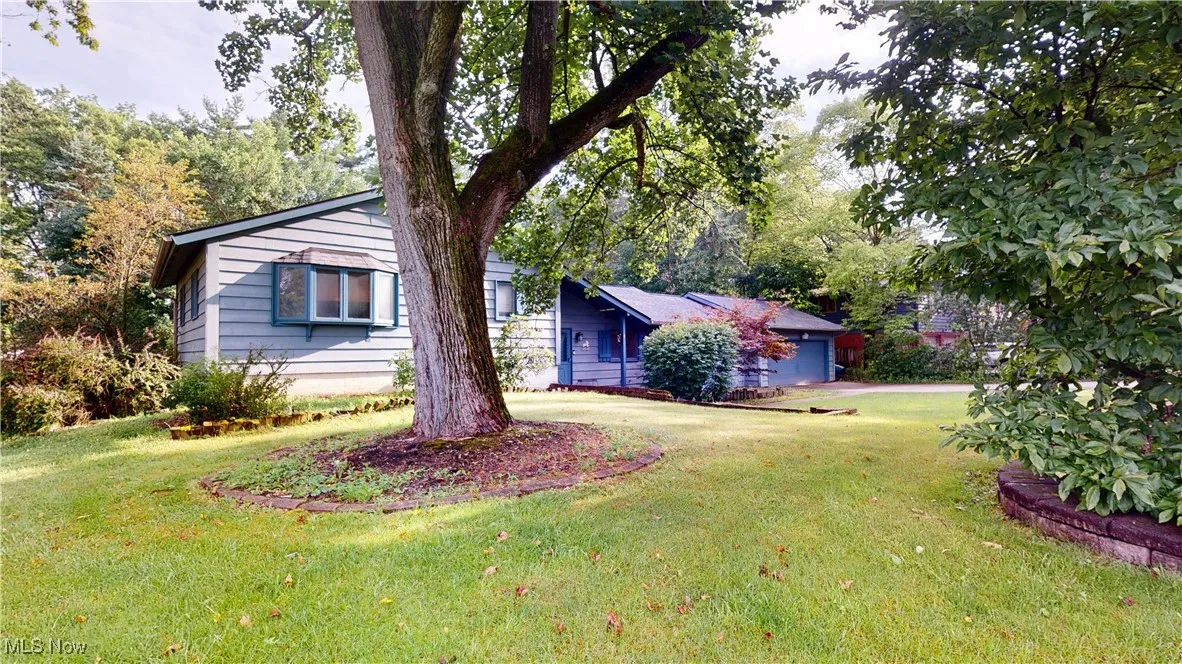View of front of home with a front yard, driveway, and a garage