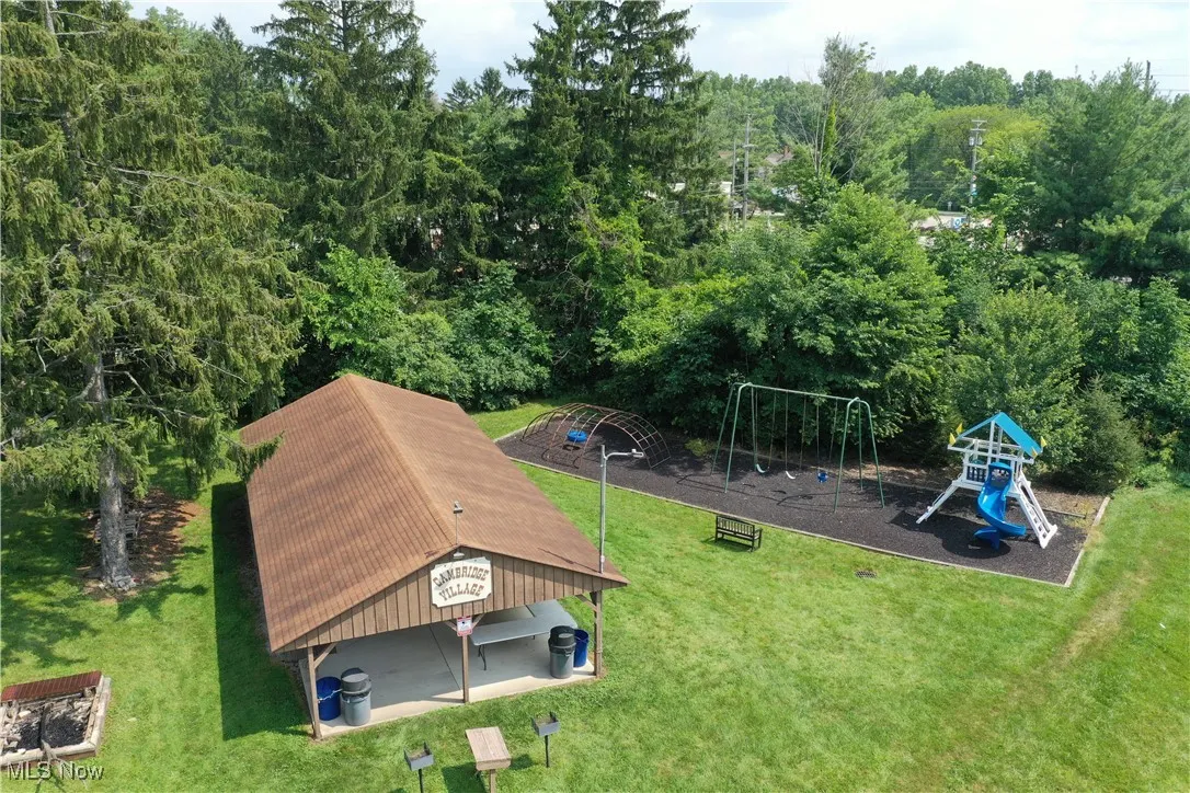 View of jungle gym with a lawn