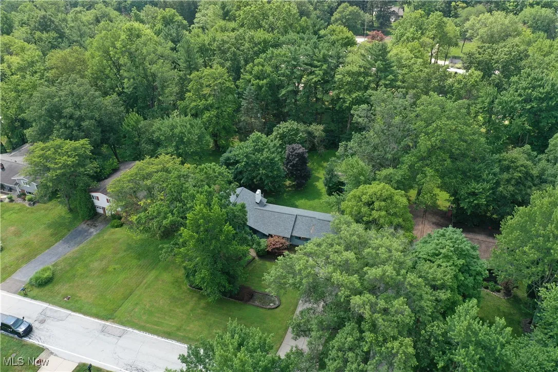 Aerial overview of property's location with a heavily wooded area