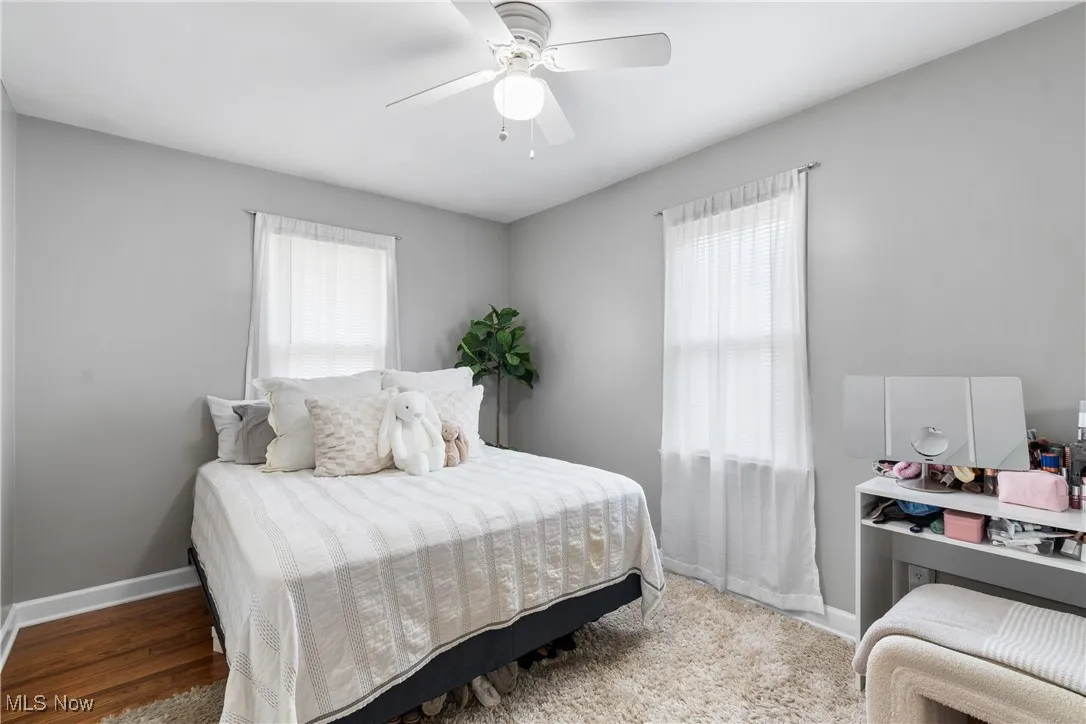 Bedroom with a ceiling fan and wood finished floors