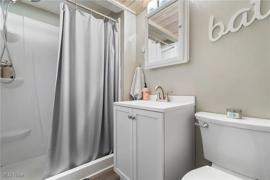 Full bathroom with vanity and curtained shower
