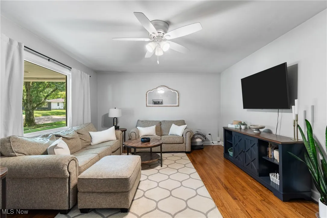 Living room featuring a ceiling fan and wood finished floors