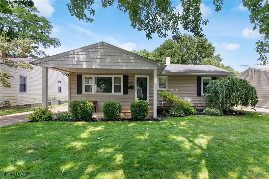 View of front of home featuring a front lawn and a chimney