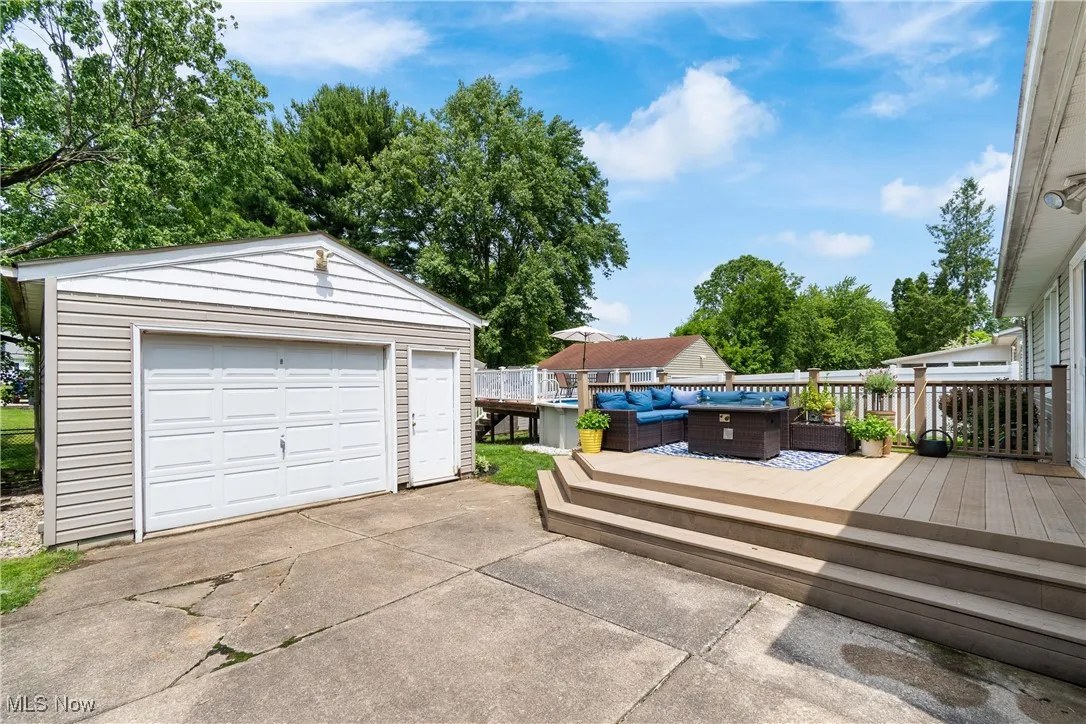 Detached garage featuring concrete driveway