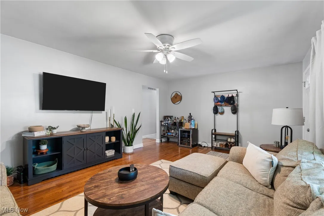 Living area featuring wood finished floors and ceiling fan
