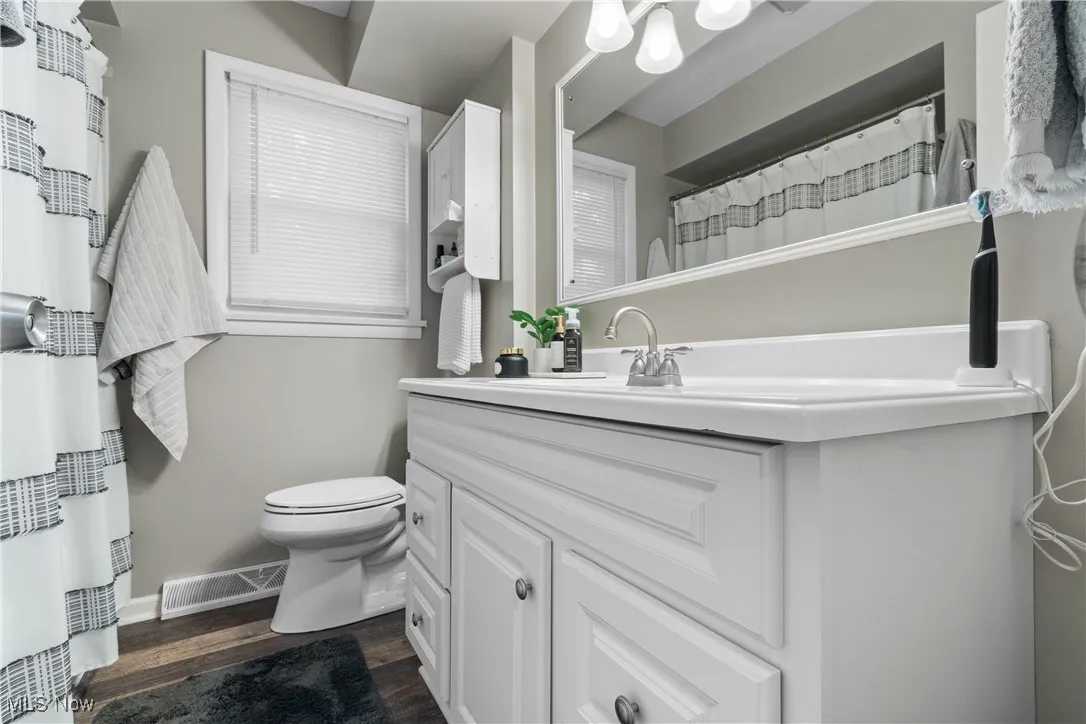 Bathroom with vanity and wood finished floors