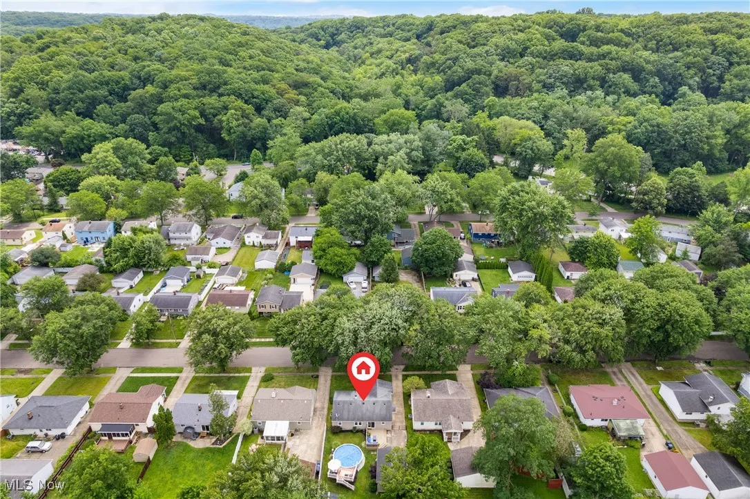 Aerial view of residential area featuring a forest