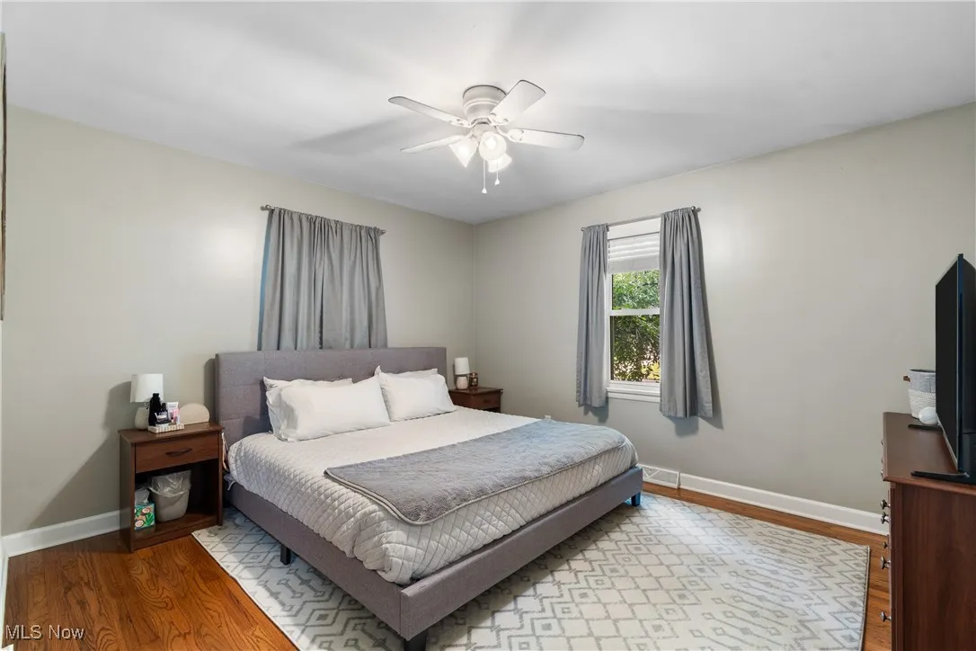 Bedroom featuring wood finished floors and ceiling fan