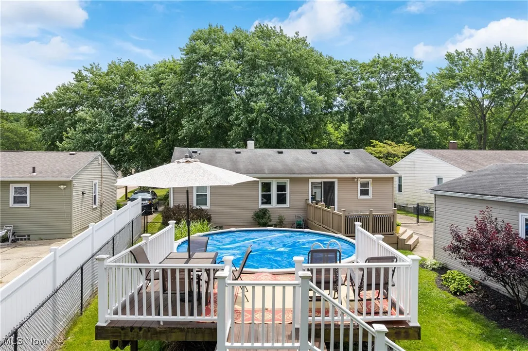 View of pool featuring a wooden deck and a fenced backyard