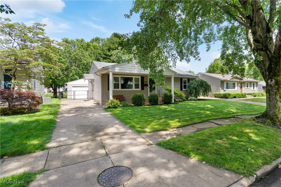 Single story home with an outbuilding, a front yard, and a detached garage