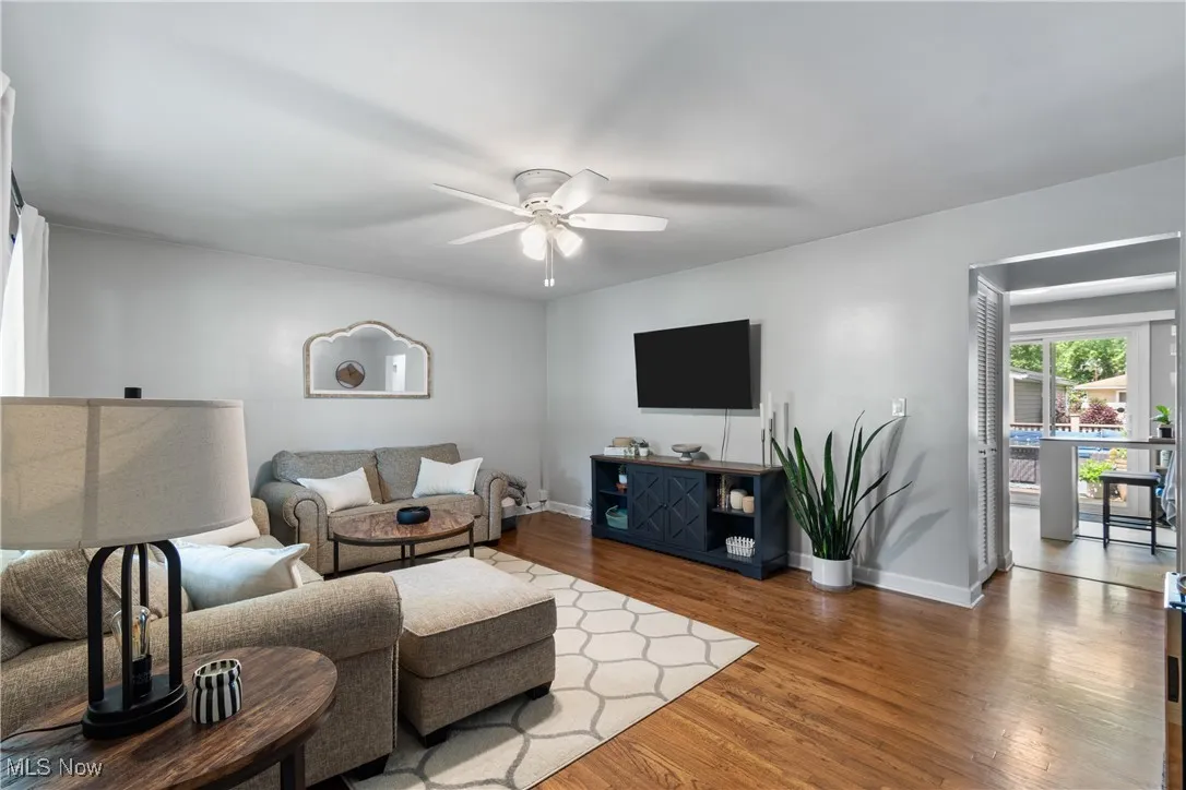 Living room featuring a ceiling fan and wood finished floors