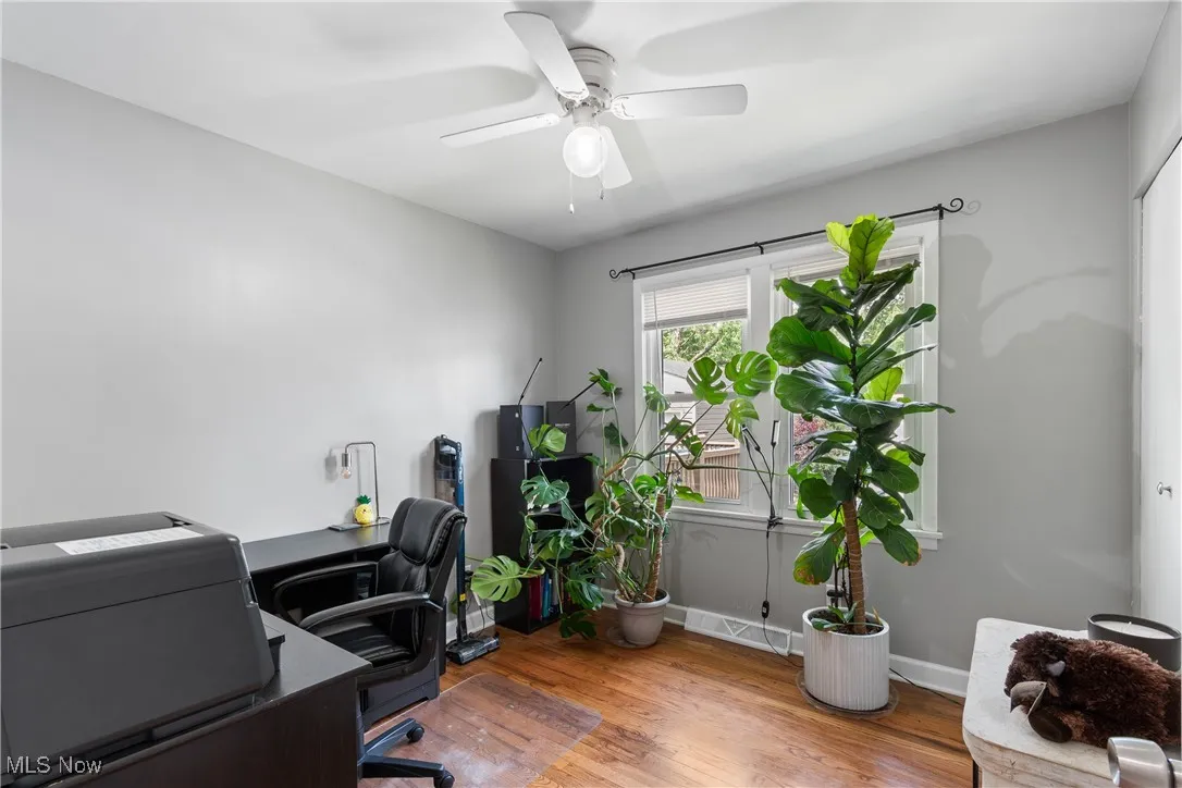 Office area featuring wood finished floors and ceiling fan