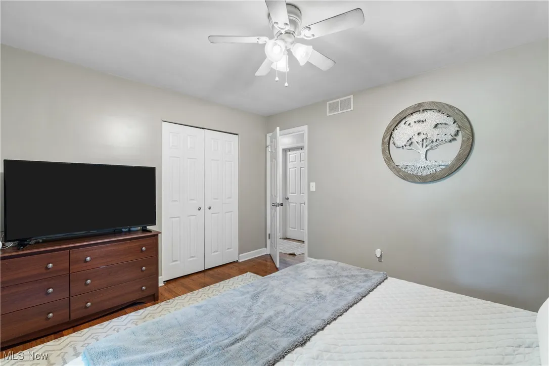 Bedroom featuring wood finished floors, ceiling fan, and a closet