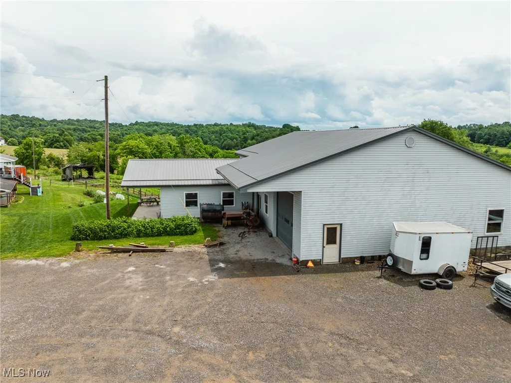 Rear view of house featuring a metal roof and a yard