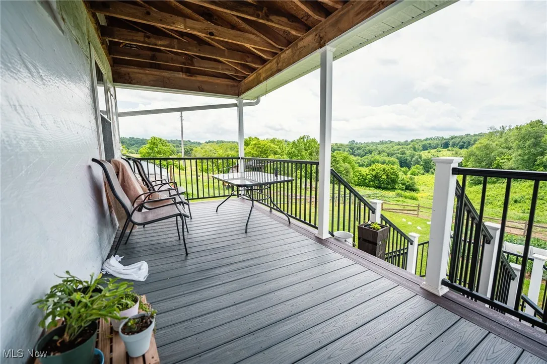 Deck featuring a wooded view