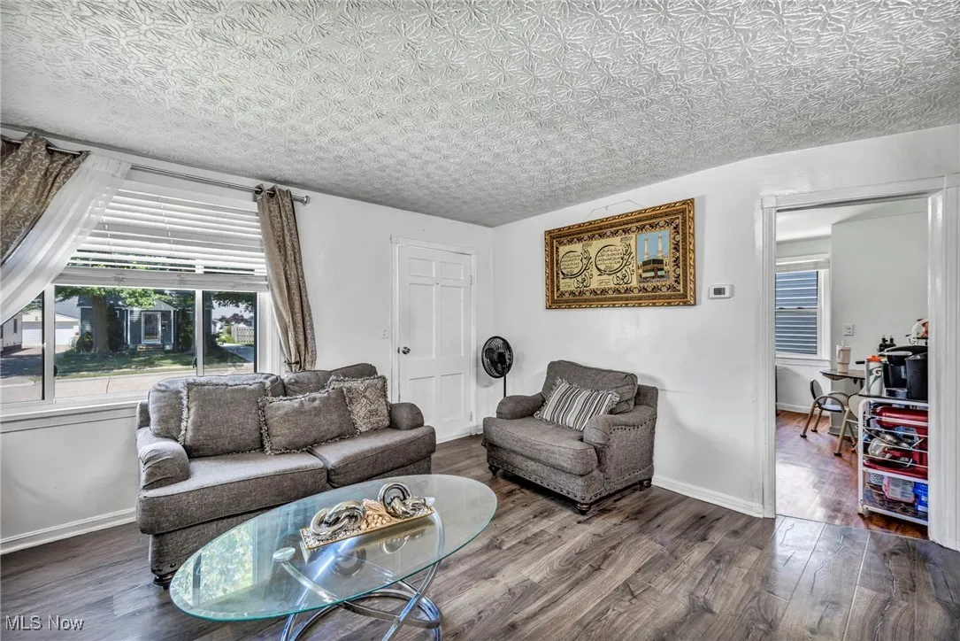 Living room featuring wood finished floors and baseboards
