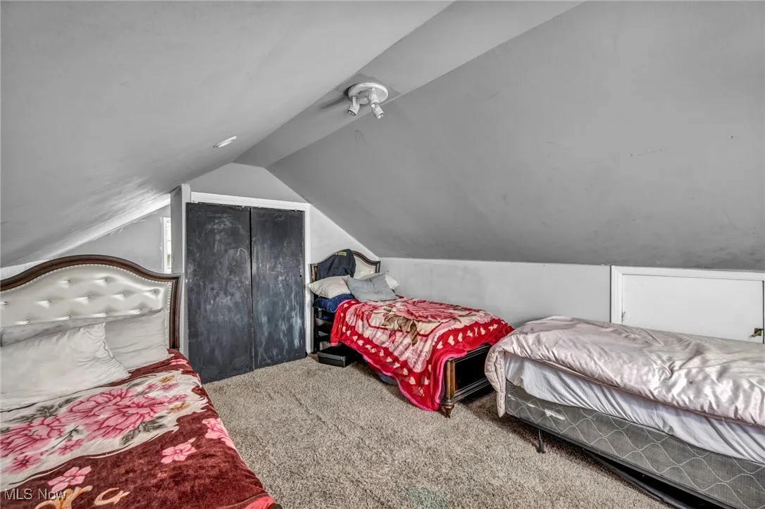 Bedroom featuring carpet floors and lofted ceiling