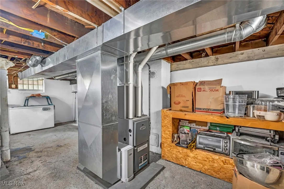 Below grade area featuring washer / dryer and heating unit