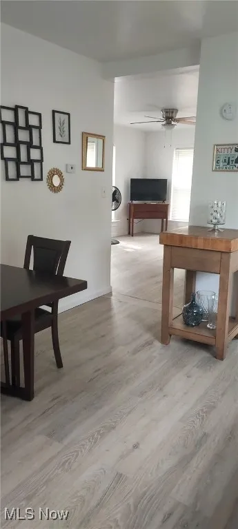 Corridor featuring wood finished floors and baseboards