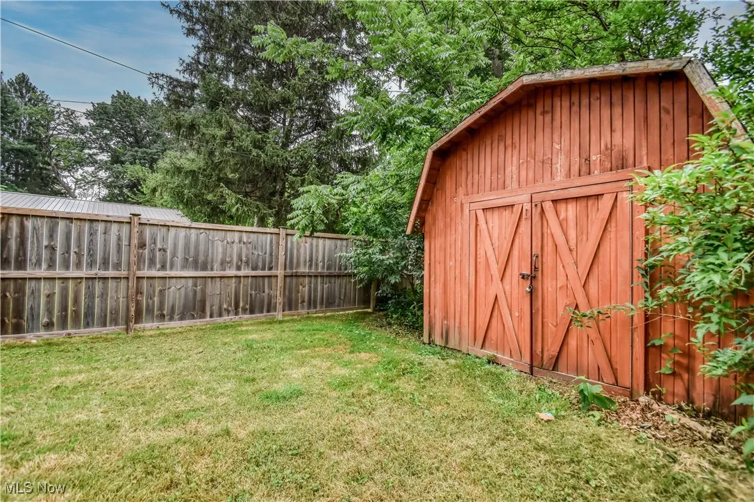 View of shed with a fenced backyard