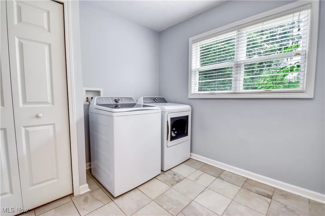 Laundry room with washer and dryer and baseboards