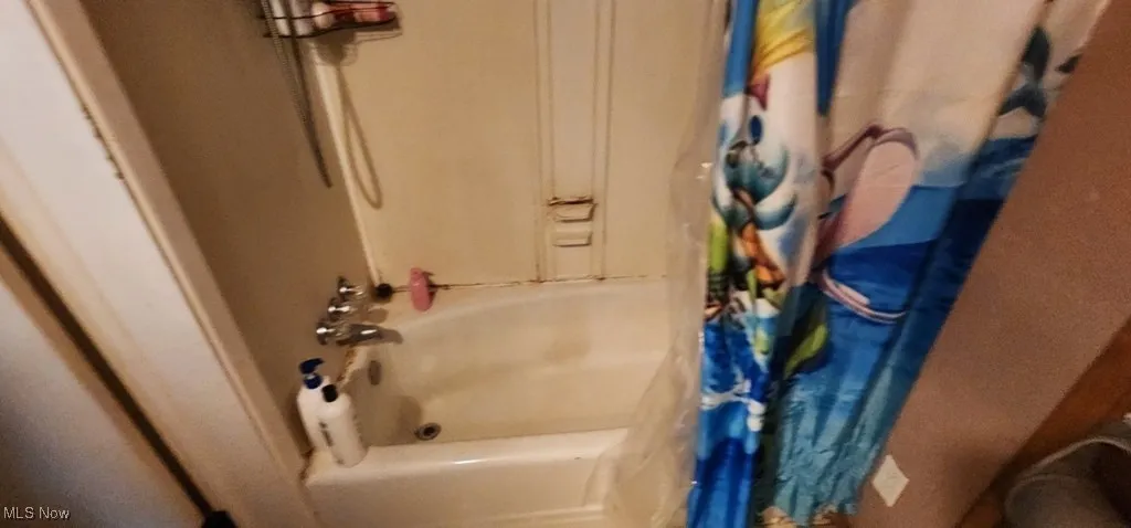Bathroom featuring shower / bath combo with shower curtain