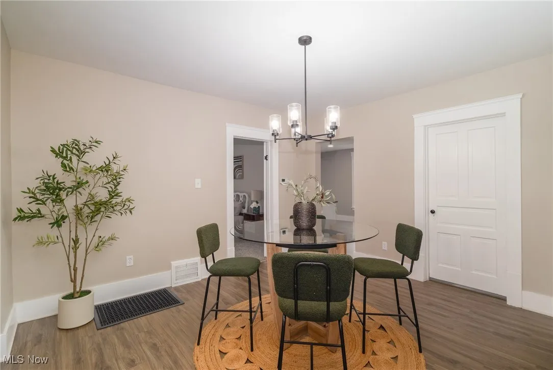 Dining space with a chandelier and wood finished floors