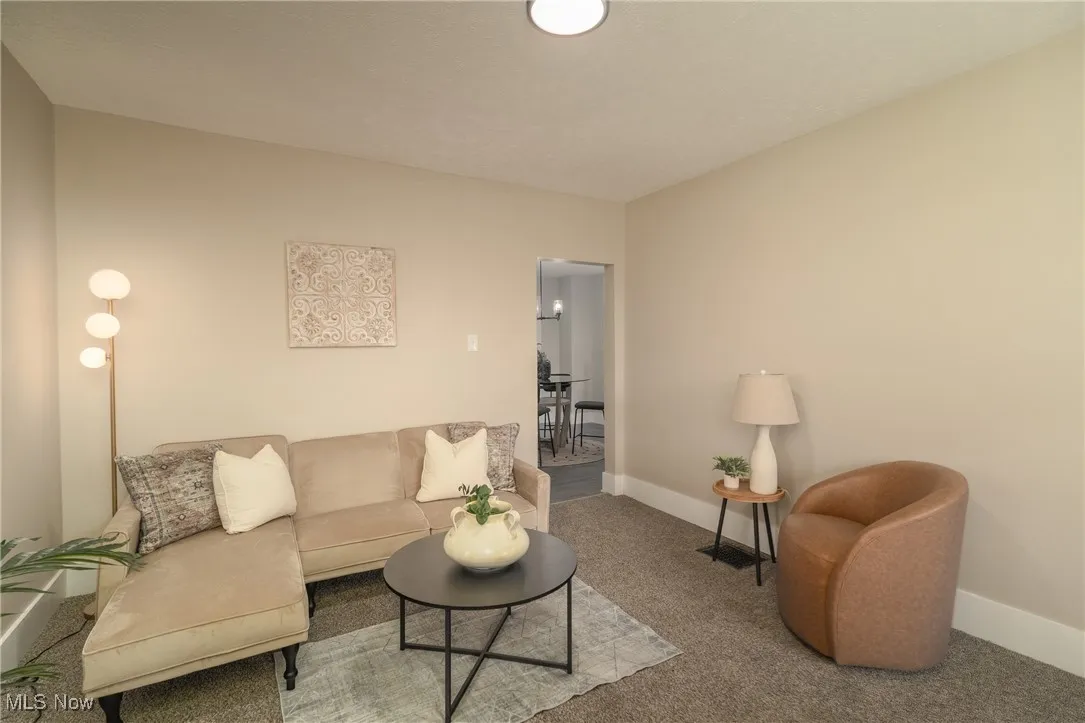 Living room with carpet floors and baseboards