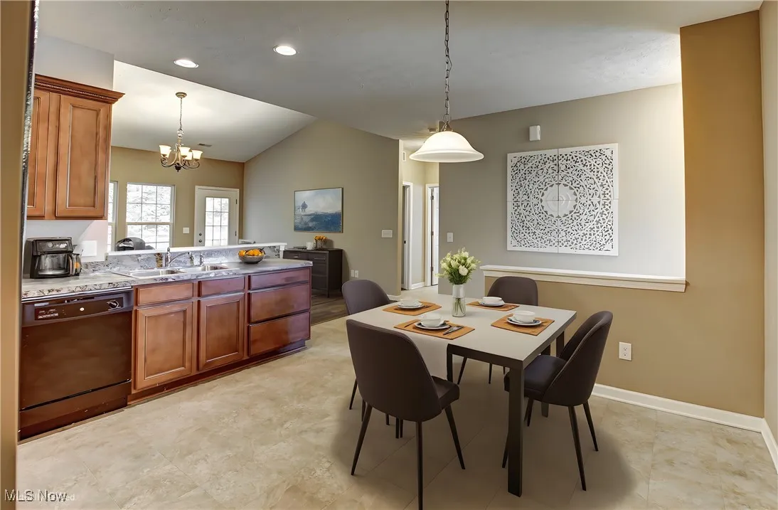 Dining area featuring recessed lighting, vaulted ceiling, and a chandelier