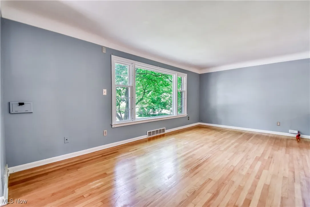 Empty room featuring wood finished floors and baseboards
