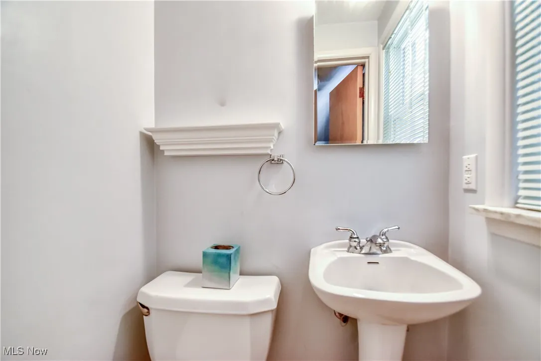 Half bath featuring toilet and a sink