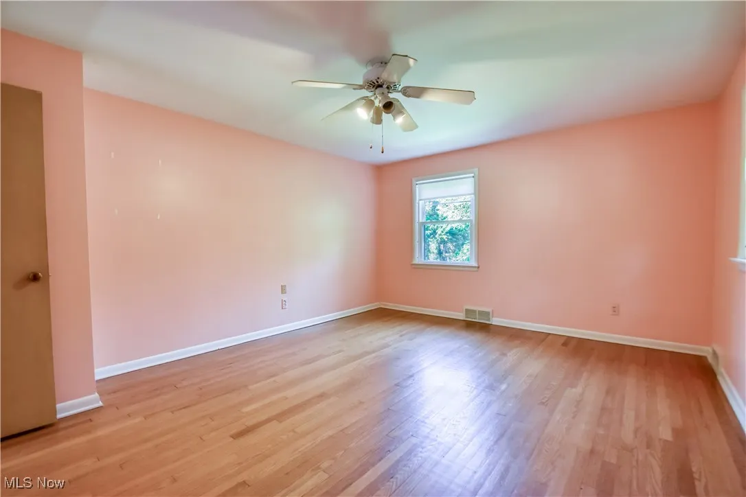 Unfurnished room with ceiling fan and light wood finished floors